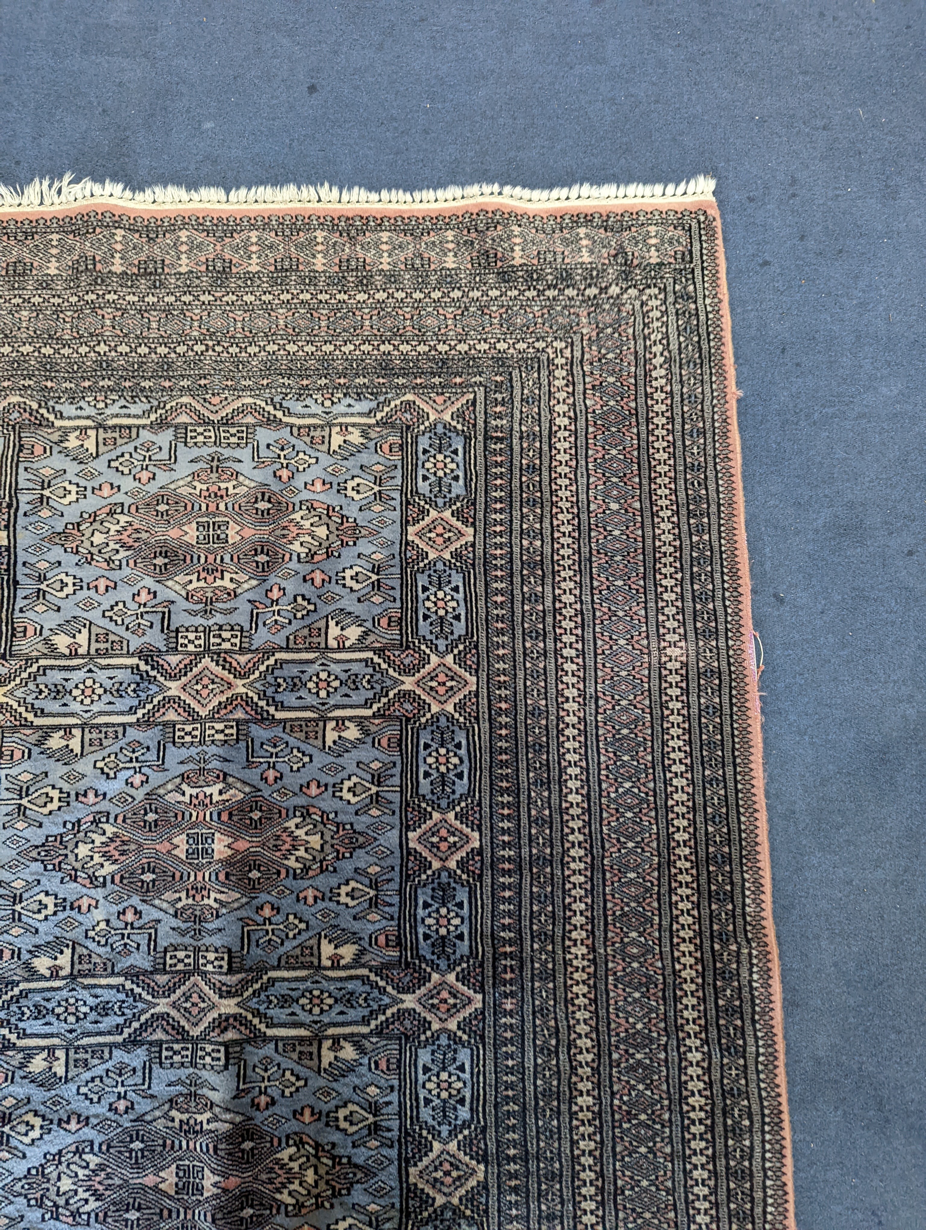 A Bokhara blue ground rug, 190 x 30cm